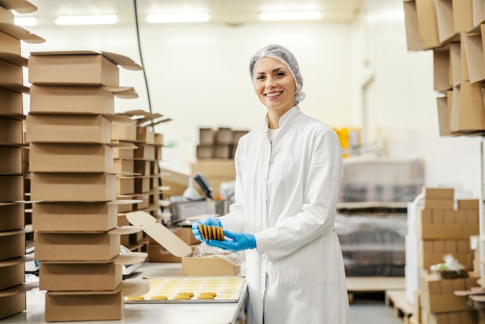 woman smiling and packing desserts into boxes